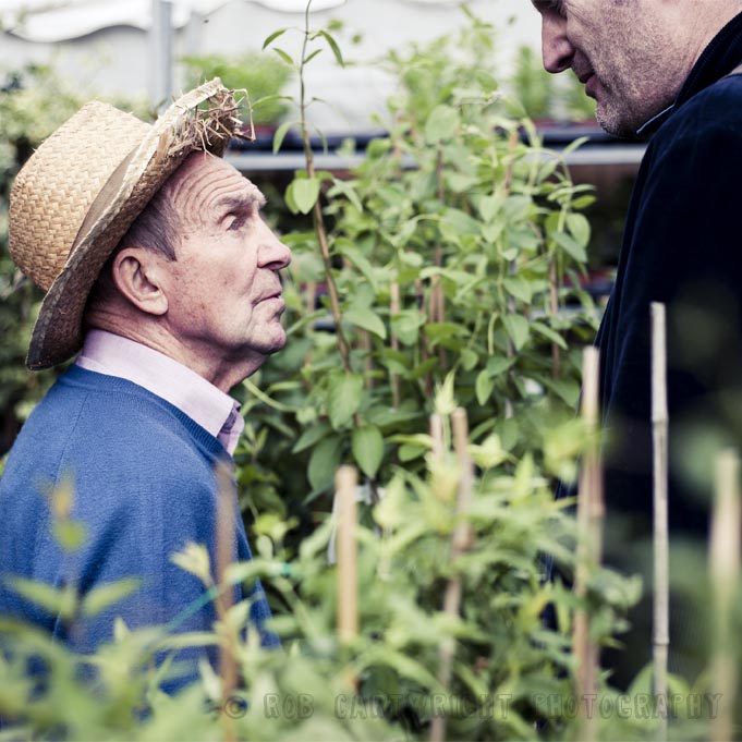 columbia road flower market tower hamlets london flowers street photography rob cartwright trader old man straw hat conversation tall short juxtaposition candid portrait